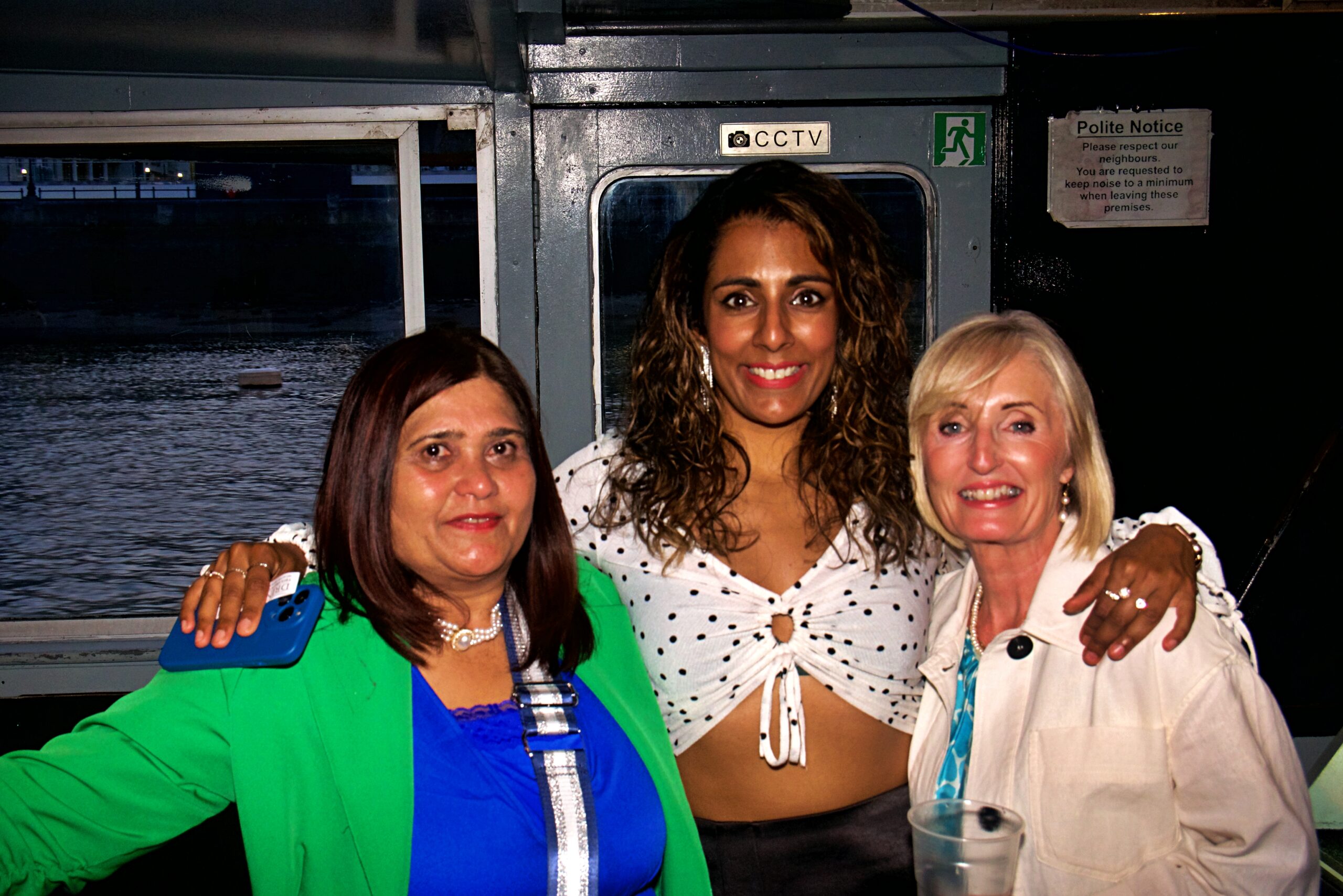 Corporate guests networking aboard a Thames party boat