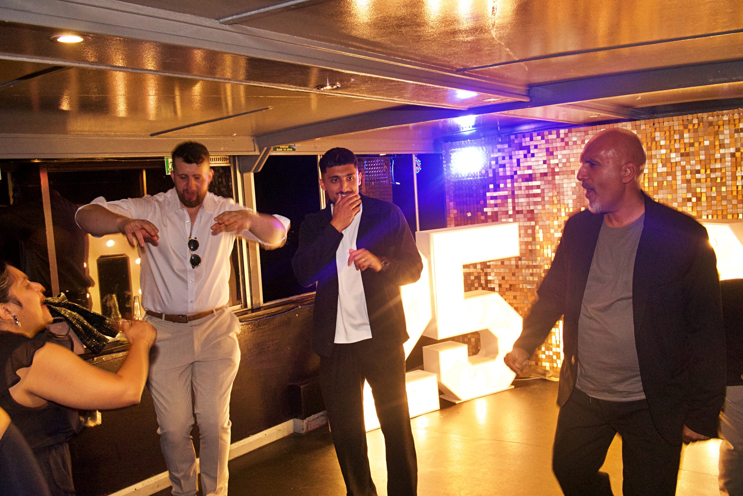 Guests celebrating a milestone birthday on a London party boat